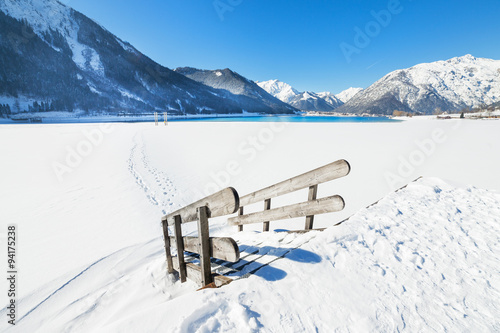 Wooden stairs covered with snow, alpine winter landscape Austria, Tirol, Achensee.