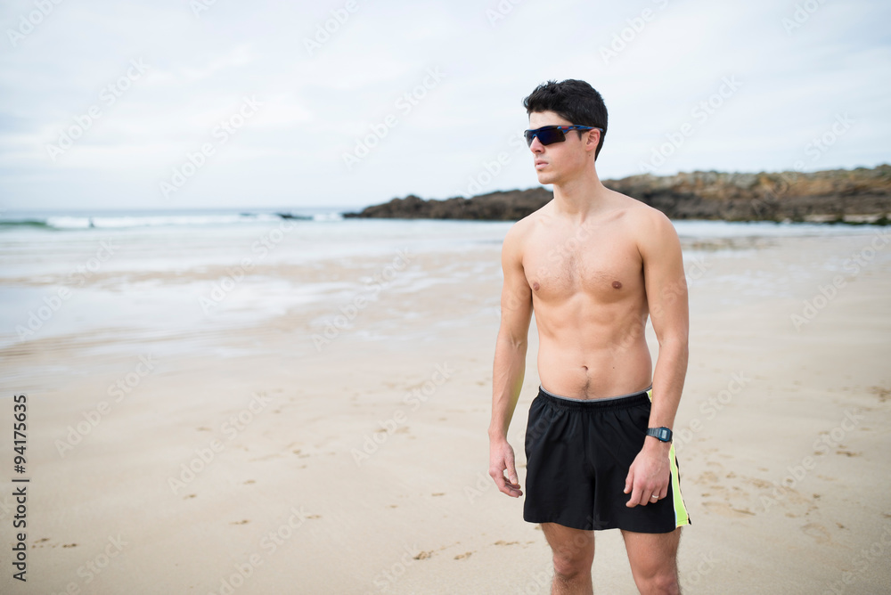 Athletic shirtless man on the beach