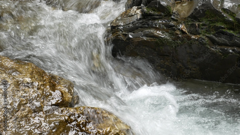 Small river streaming over wet rocks Small river streaming over wet rocks