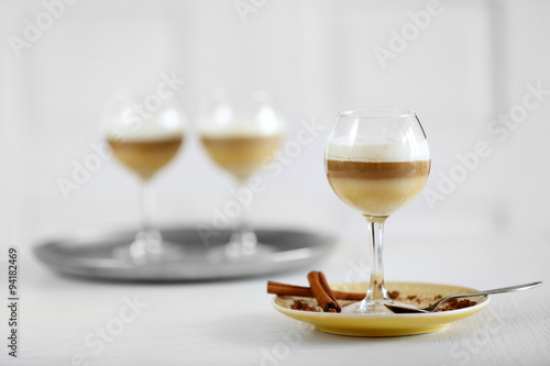 Wine glass with jelly on table, on light background