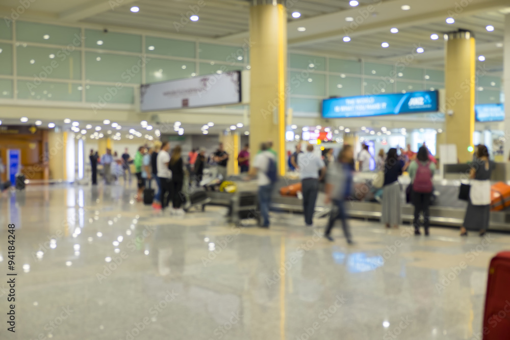 Blur focus of people waiting luggage at Baggage claim.