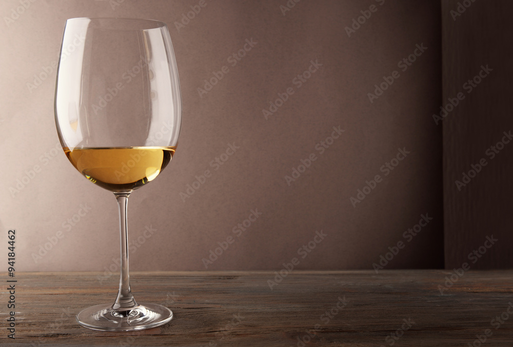 Glass of white wine on wooden table Glass of white wine on wooden table