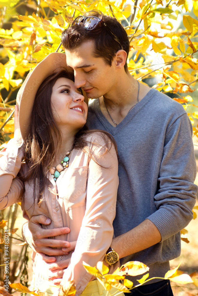 Fototapeta premium Happy couple hugging on the autumn background