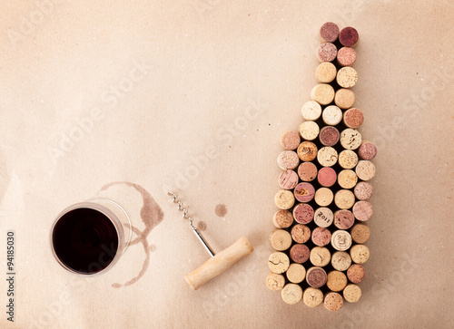 Wine bottle shaped corks, glass of wine and corkscrew
