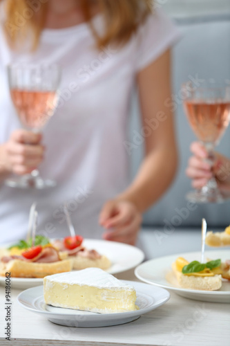 Friends hands with glasses of wine and snacks   close up