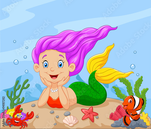 Happy little mermaid laying on the sand