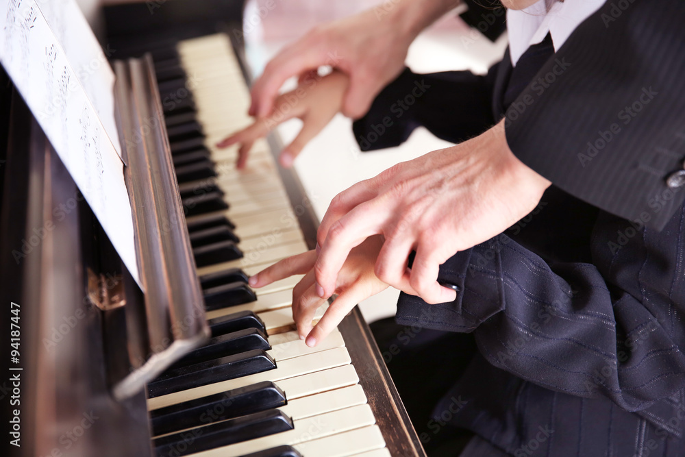 Close up of musician man and girl hands piano playing Close up of musician man and girl hands piano playing