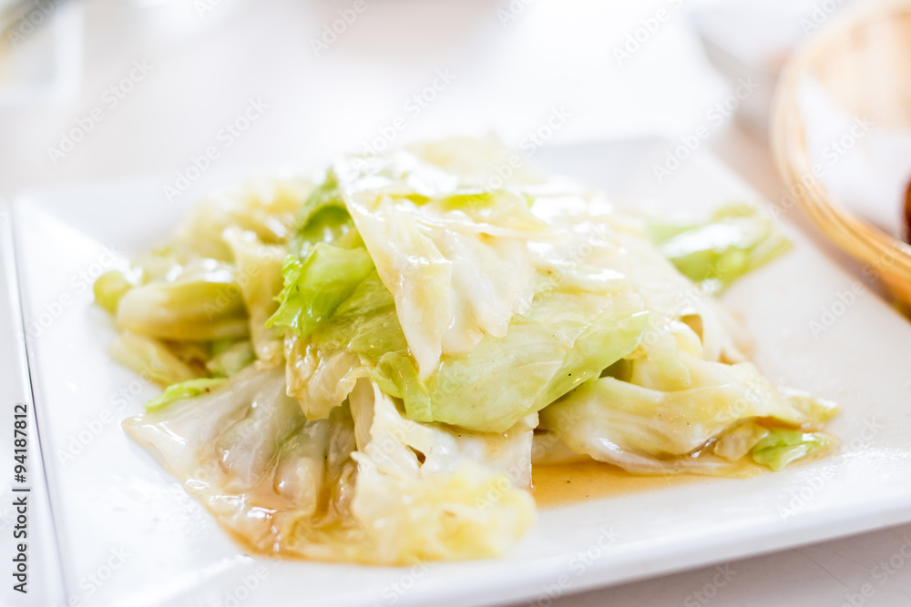 Fried cabbage with Shell oil on white plate,Thai food style Fried cabbage with Shell oil on white plate,Thai food style