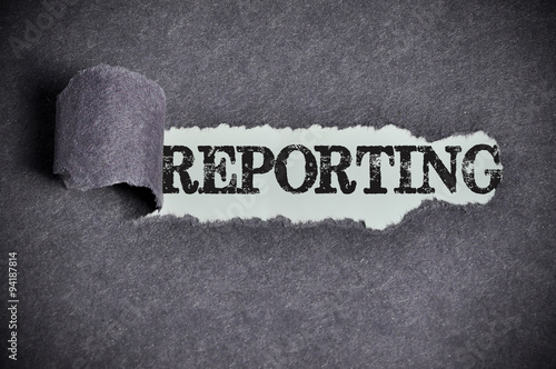 reporting word under torn black sugar paper