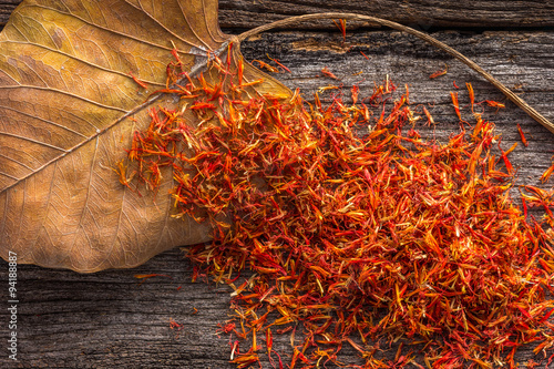 Valokuva Dry Safflower with leaf  on grunge wooden background.