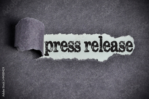 press release word under torn black sugar paper