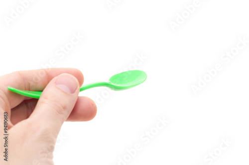 Hand holding spoon. All on white background