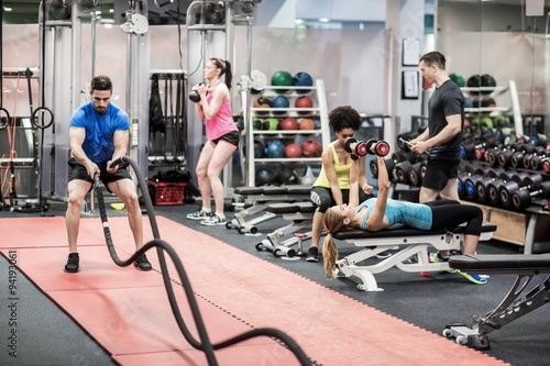 Fit people working out in weights room photo