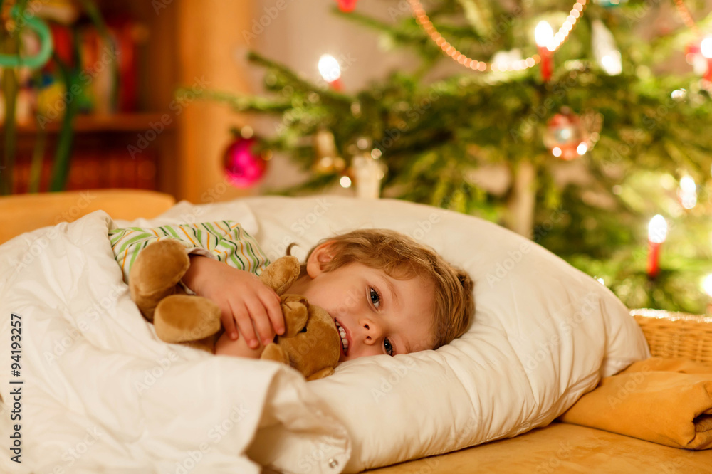 Little cute blond child sleeping under Christmas tree Little cute blond child sleeping under Christmas tree