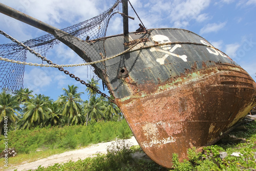 Rusty old pirate ship on the shore of the island. La Digue