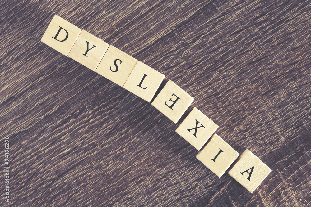 Dyslexia word formed with wooden blocks. Reading difficulties concept. Cross processed image with shallow depth of field Dyslexia word formed with wooden blocks. Reading difficulties concept. Cross processed image with shallow depth of field