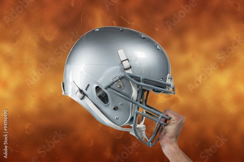 American football helmet grabbed by player