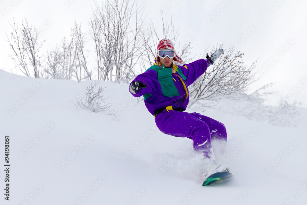 Awesome snowboarder is having fun in the backcountry powder of Les Portes du Soleil in France