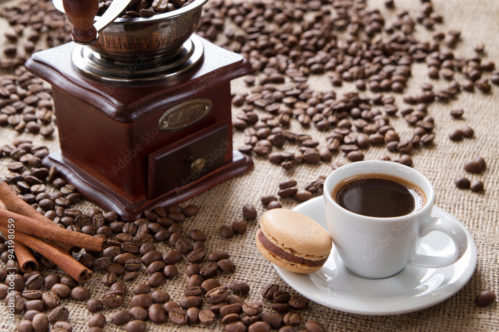 cup of coffee with macarons on a background coffee beans