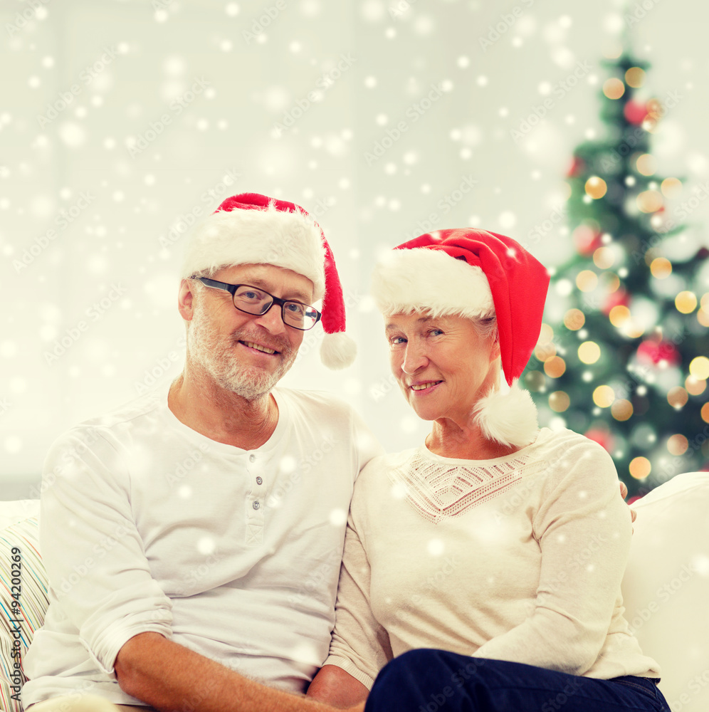 happy senior couple in santa helper hats at home happy senior couple in santa helper hats at home