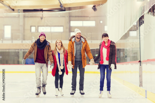 happy friends on skating rink