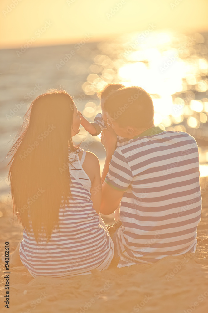 Fototapeta premium happy parents with baby on the beach 