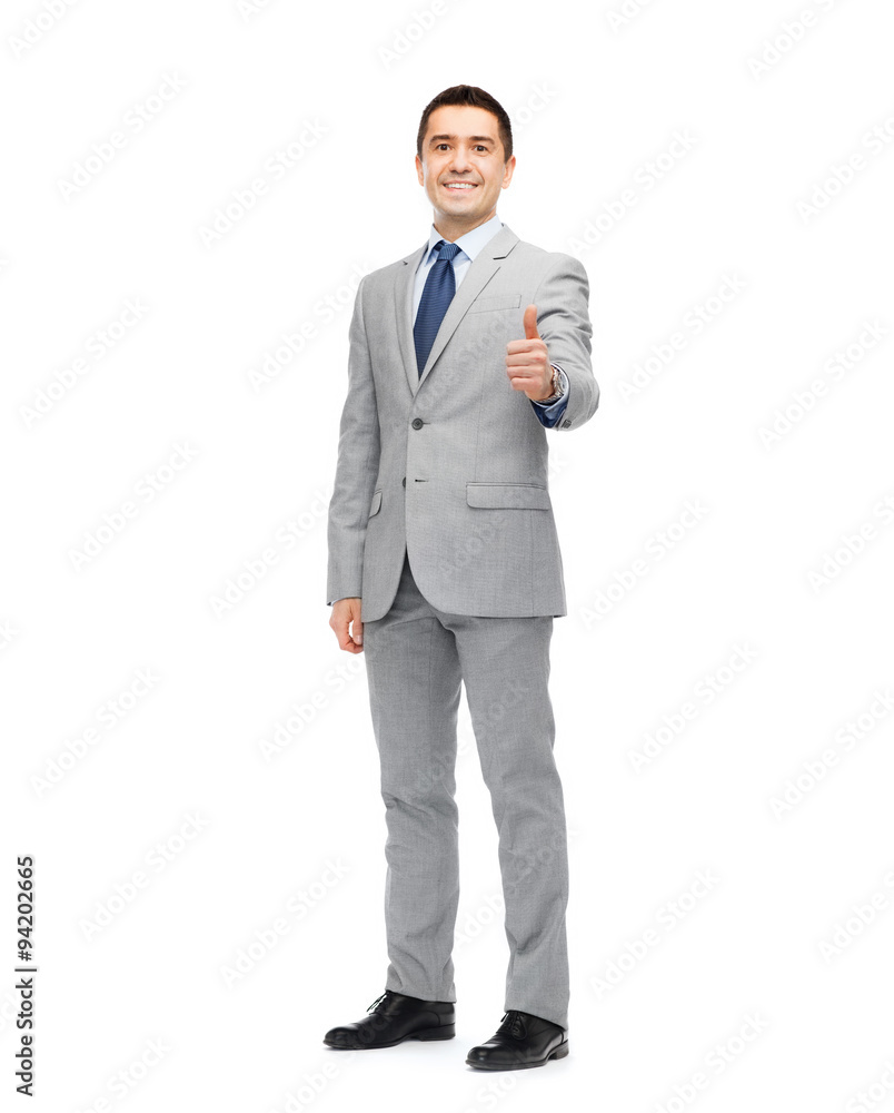 happy businessman in suit showing thumbs up happy businessman in suit showing thumbs up