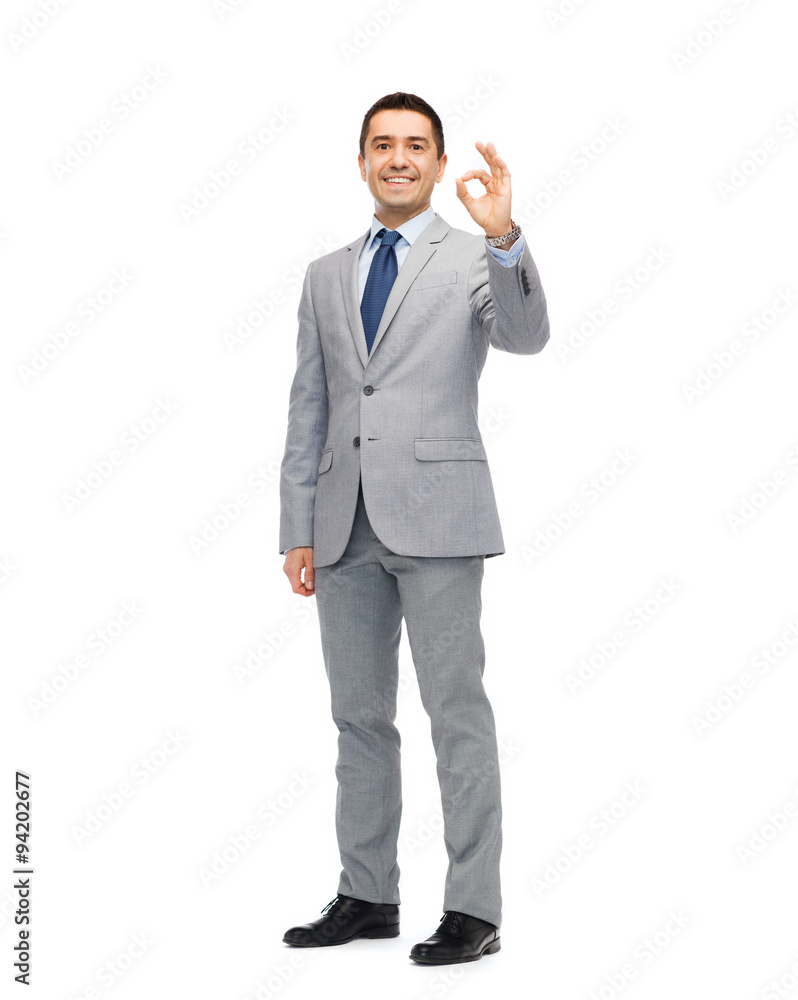 happy businessman in suit showing ok hand sign happy businessman in suit showing ok hand sign