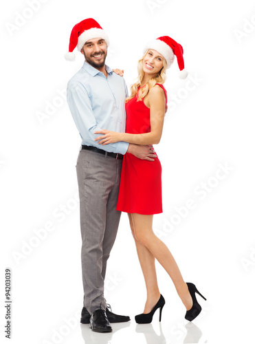 happy couple in santa hats hugging