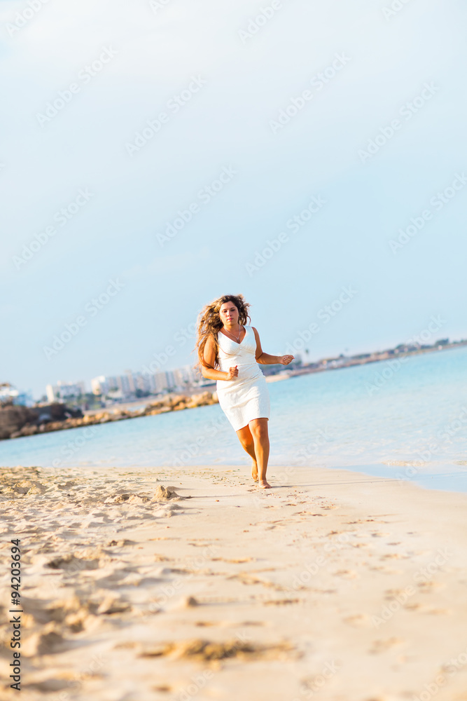 Happy beautiful woman running on the beach. Happy beautiful woman running on the beach.