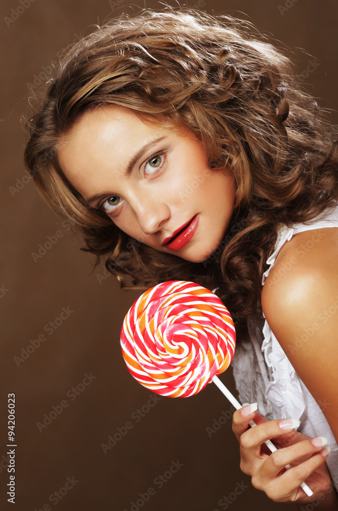 Lollipop in hand. Beautiful  girl with  candy.