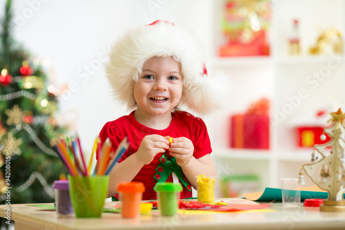 Kid girl making by hands x-...