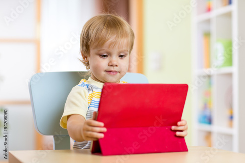 Portrait child using laptop...