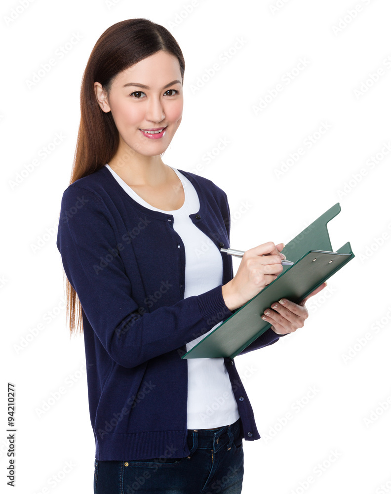 Young woman take note on clipboard Young woman take note on clipboard