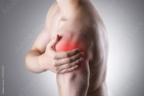 Man with pain in shoulder. Pain in the human body photo