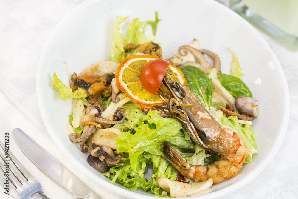 seafood salad on a plate on a white background seafood salad on a plate on a white background