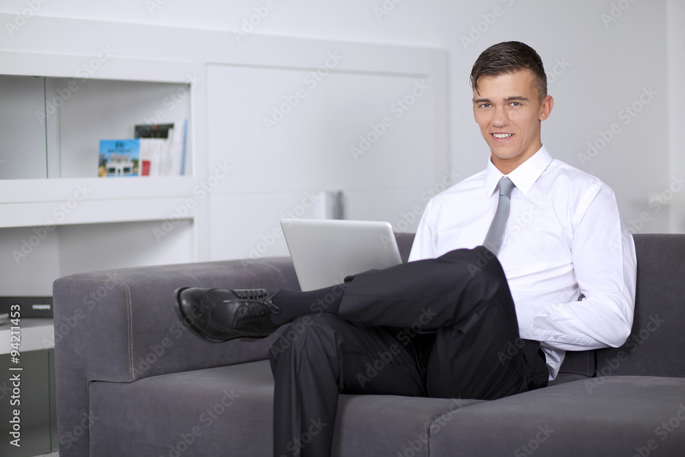 Successfull businessman working with a notebook and sitting on c Successfull businessman working with a notebook and sitting on c