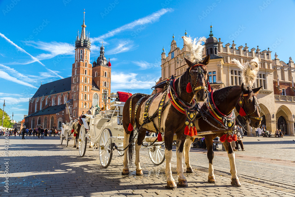 Fototapeta premium Horse carriages at main square in Krakow