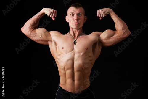 young bodybuilder showing double biceps