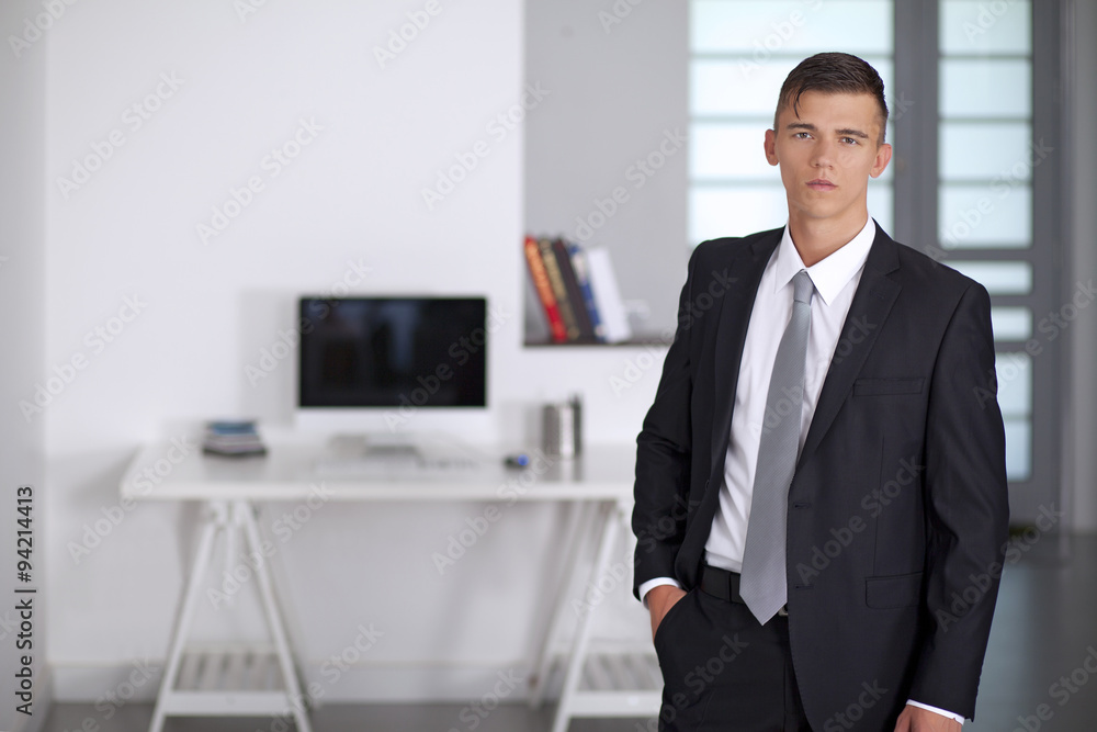 Businessman posing with hand in his pocket Businessman posing with hand in his pocket
