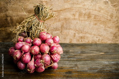 Raw shallot on wooden background