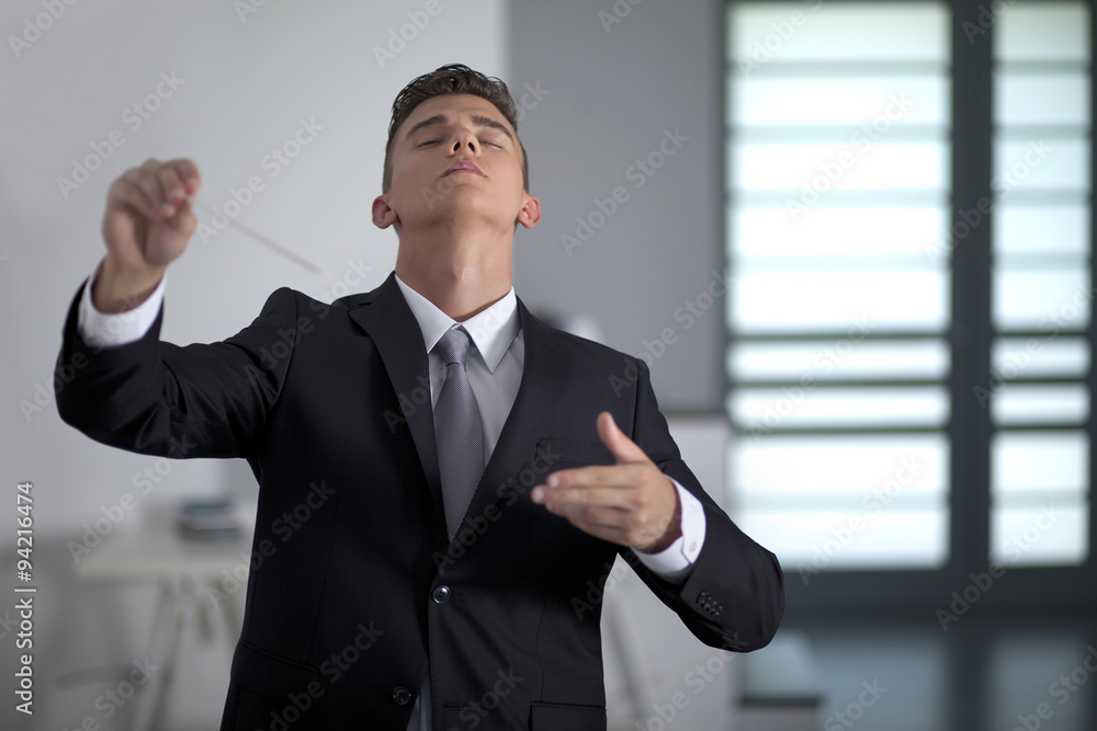 Businessman conducting his work and business with his baton Businessman conducting his work and business with his baton