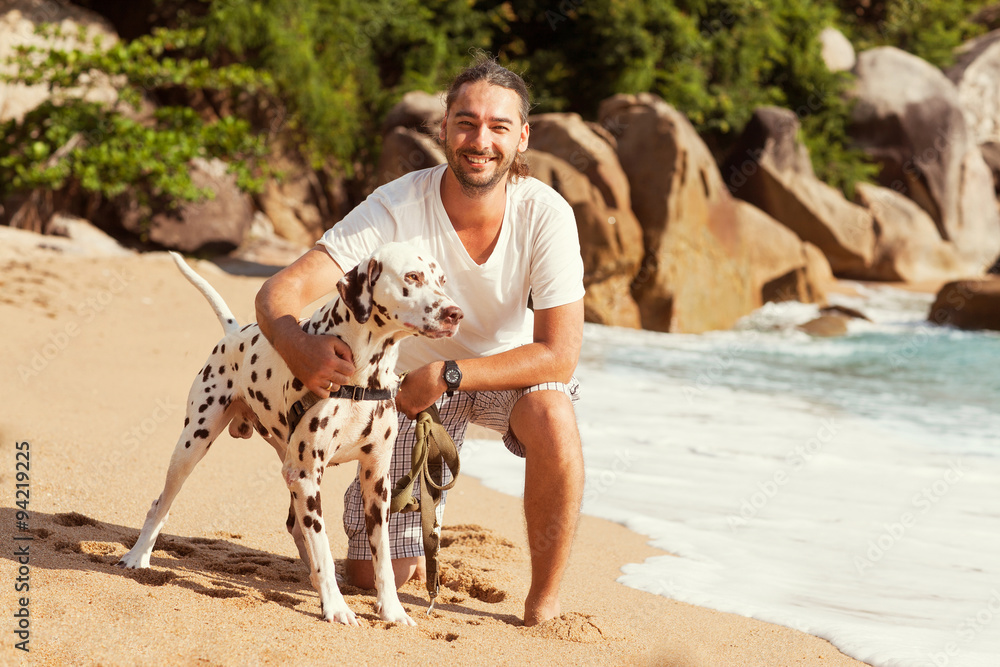 man with dog on the tropical beach man with dog on the tropical beach
