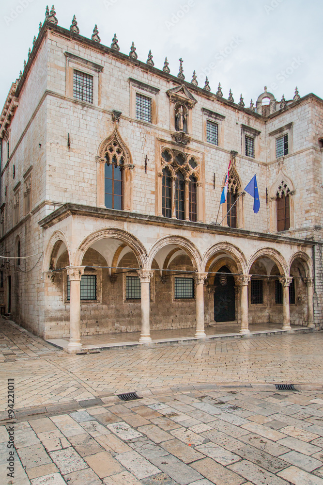      Sponza Palace in Dubrovnik with flag of Croatia and European Union. Sponza Palace was built in 16th century. 