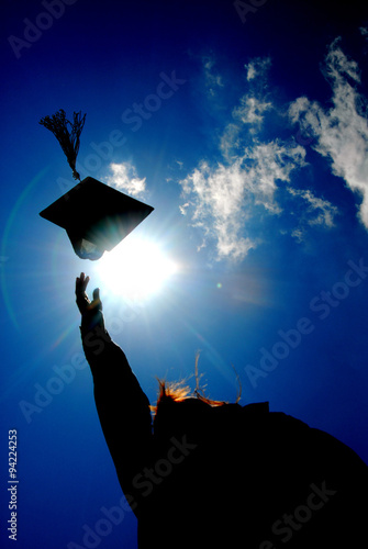 Fotografie A graduate tosses a cap.