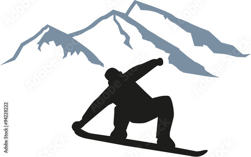 Snowboarder jumping in front of mountain silhouette