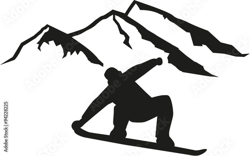 Snowboarder driving in front of hills