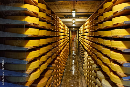 Round stacks of cheese curing in a cellar of Maison du Gruyere c