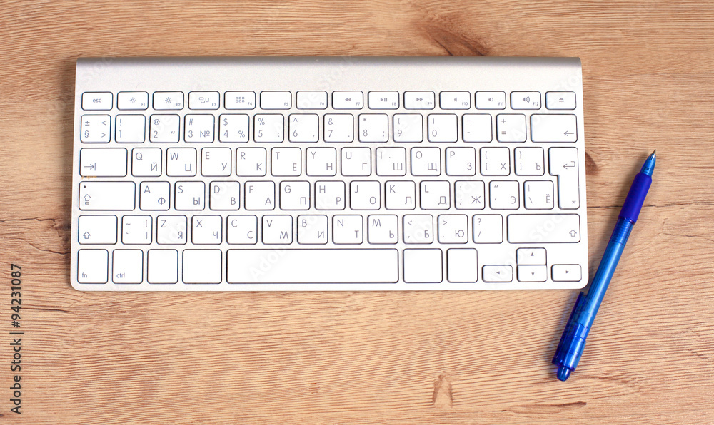 Modern aluminum computer keyboard on the table