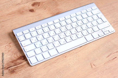 Modern aluminum computer keyboard on the table
